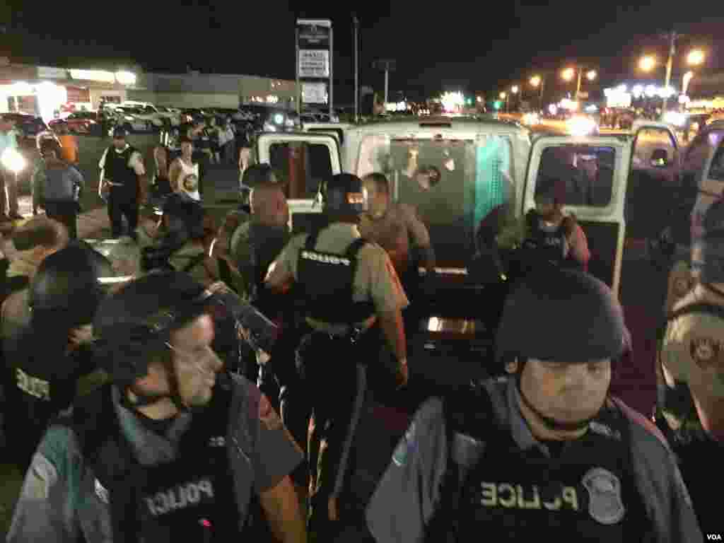 Police make an arrest on West Flourissant in Ferguson, Missouri, August 10, 2015. (Kane Farabaugh/VOA News)