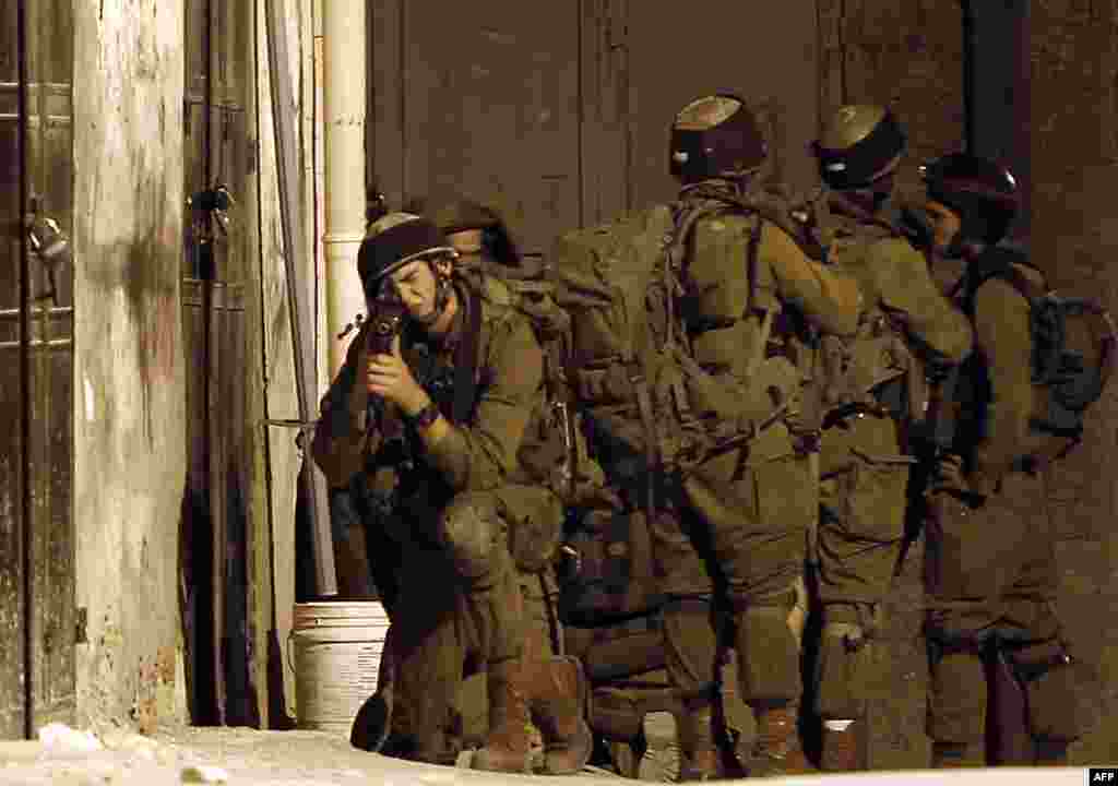 Israeli soldiers take part in a search operation in the West Bank village of Awarta as part of the operation to locate the three teenagers the army believes were abducted by Islamist movement Hamas on June 12. 