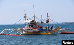 FILE - A fishing boat used to fish in the disputed Scarborough Shoal, in the South China Sea, is pictured in Masinloc, Zambales in the Philippines.