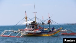 FILE - A fishing boat used to fish in the disputed Scarborough Shoal, in South China Sea is pictured in Masinloc, Zambales in the Philippines.