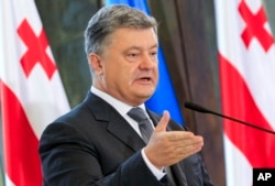 Ukrainian President Petro Poroshenko speaks at a press conference during his meeting with Georgian President Georgy Margvelashvili in Tbilisi, Georgia, July 18, 2017. Poroshenko has called the seperatist leaders in eastern Ukraine "puppets" which take their orders from Moscow.