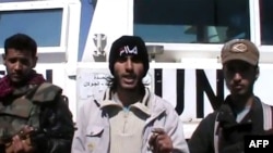 An image taken from a video uploaded on YouTube on March 6, 2013 allegedly shows armed fighters standing in front of a United Nations Disengagement Force (UNDOF) vehicle in the Golan Heights between Syria and Israel. (AFP/YouTube)