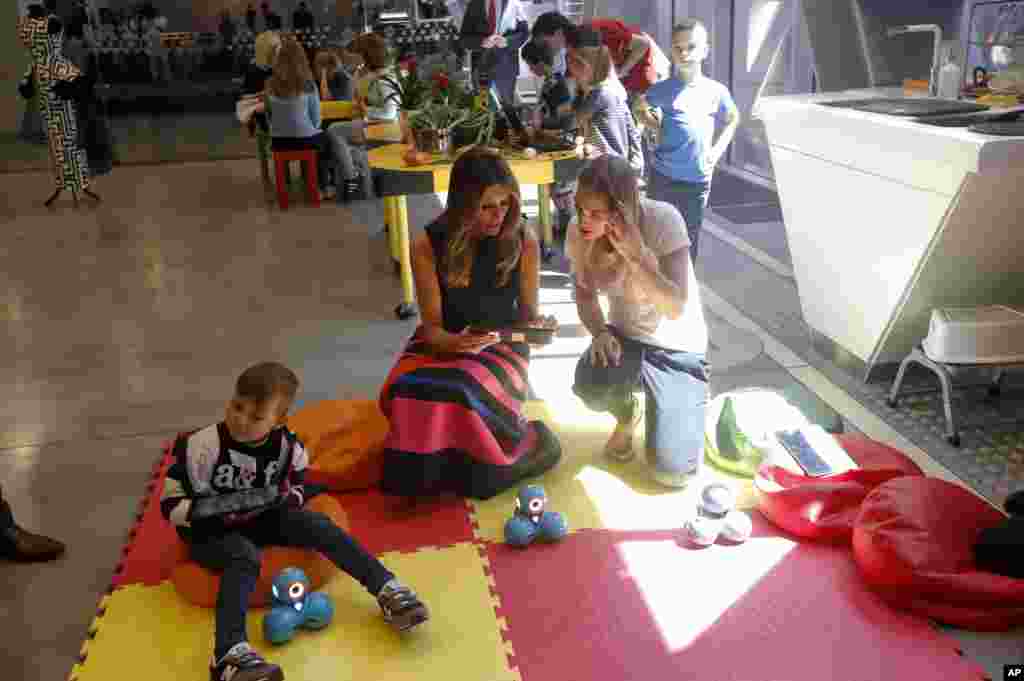 U.S. First Lady Melania Trump, center left, sits with children during a visit at the Copernicus Science Center, an interactive science museum geared heavily to young people, in Warsaw, Poland, July, 6, 2017.