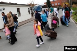Syrian refugees arrive at the camp for refugees and migrants in Friedland, Germany, April 4, 2016.