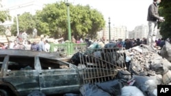A burned vehicle, piles of rubble and trash in Tahrir Square, Cairo, Egypt, February 12, 2011
