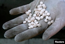 A Bulgarian customs officer displays Captagon pills confiscated in Sofia, Dec. 12, 2007.