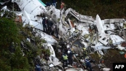 FILE - Rescuers search for survivors from the wreckage of the charter plane carrying members of the Chapecoense soccer team that crashed in the mountains of Cerro Gordo, Colombia, Nov. 29, 2016.
