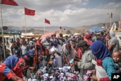 Berber villagers shop for garments at the annual festival of Imilchil, a small village in Morocco's Atlas mountains, Sept. 22, 2017.