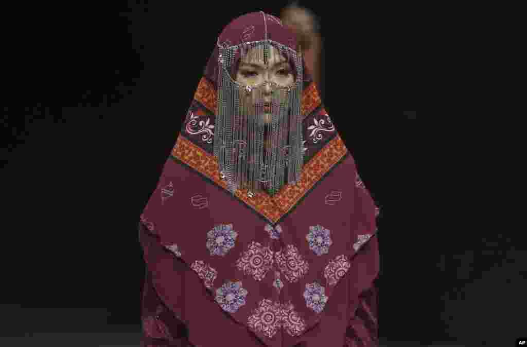 A model displays a creation by Nada Rivani during the Muslim Fashion Festival in Jakarta, Indonesia.