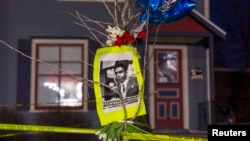 A makeshift memorial pays tribute to a 19-year-old black man killed by police, in front of a home cordoned off with barricade tape on Williamson Street in Madison, Wisconsin, March 7, 2015. 