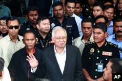 Former Malaysian Prime Minister Najib Razak, center, speaks to media as he leaves the Malaysian Anti-Corruption Commission (MACC) Office in Putrajaya, Malaysia, May 24, 2018.