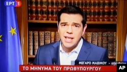 In this photo taken from television Greece's Prime Minister Alexis Tsirpas delivers a televised address to the nation from his office at Maximos Mansion in Athens, July 1, 2015. Tsipras has vowed to push on with his plan for a referendum this Sunday on the recent proposals from the country's creditors.