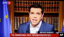 In this photo taken from television Greece's Prime Minister Alexis Tsirpas delivers a televised address to the nation from his office at Maximos Mansion in Athens, July 1, 2015. Tsipras has vowed to push on with his plan for a referendum this Sunday on th