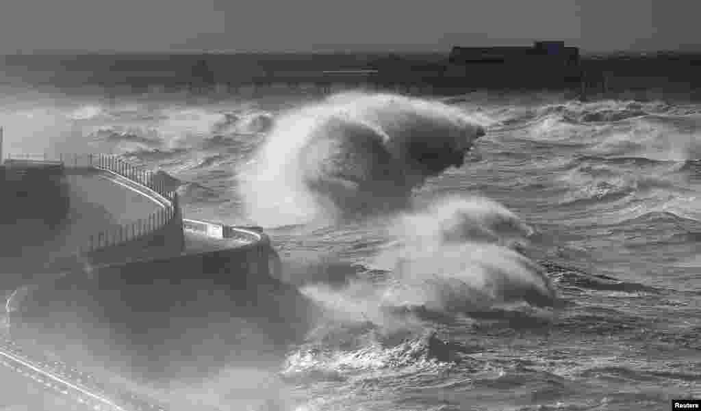 Waves break in front of the South Pier on Blackpool Promenade, northern Britain. Abigail, the first named storm to hit Britain, whipped up winds of up to 84 miles per hour and cut power to 12,000 homes.