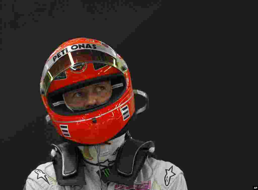 Michael Schumacher looks up at a monitor in his garage during the second practice session for the Korean Formula One Grand Prix at the Korean International Circuit in Yeongam, Oct. 14, 2011. 