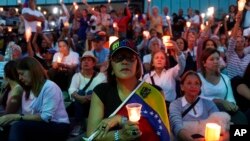 Opponents to Venezuela's President Nicolas Maduro hold a vigil for those killed in street fighting over the past week in Caracas, Venezuela, May 5, 2019.