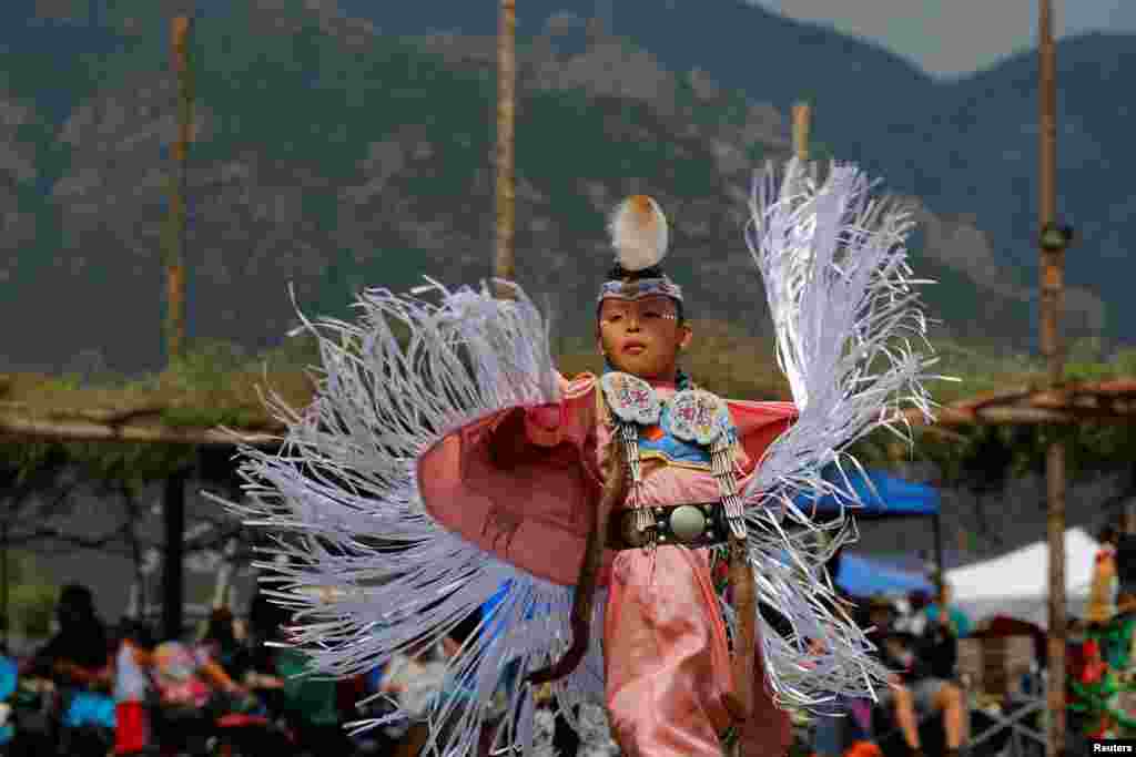 Seven-year-old Kelly Dee, who is Navajo Hopi, competes in junior girls&#39; fancy shawl category on the second day of the 32nd Annual Taos Pueblo Pow Wow, a Native American dance competition and social gathering, in Taos, New Mexico, July 8, 2017.