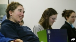 In this 2006 file photo, Emma Notis-McConarty of Newton, Mass., left, smiles during her final SAT prep class at Kaplan Test Prep and Admissions. (AP Photo/Julia Malakie)