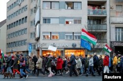 FILE - People attend a rally in support of the Soros-founded Central European University in Budapest, Hungary, Nov. 24, 2018.