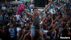 Palestinians celebrate following announcement of a cease-fire in Gaza City Aug. 26, 2014. 