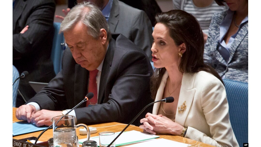 U.N. High Commissioner for Refugees Antonio Guterres listens as U.N. Special Envoy for Refugees Angelina Jolie Pitt addresses the Security Council on Syria's refugee crisis, April 24, 2015.