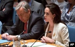 U.N. High Commissioner for Refugees Antonio Guterres listens as U.N. Special Envoy for Refugees Angelina Jolie Pitt addresses the Security Council on Syria's refugee crisis, April 24, 2015.