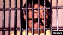 FILE - Mexican drug lord Rafael Caro Quintero is shown behind bars in this undated photo.