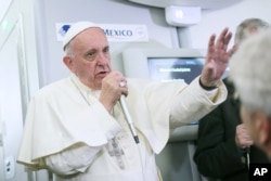 Pope Francis speaks to journalists aboard his plane during his flight from Ciudad Juarez, Mexico, to Rome, Italy, Feb. 17, 2016.