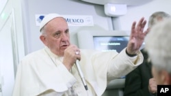 Pope Francis speaks to journalists aboard his plane during his flight from Ciudad Juarez, Mexico, to Rome, Italy, Feb. 17, 2016.