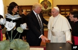 Pope Francis exchanges gifts with President Donald Trump and First Lady Melania Trump, on the occasion of their private audience, at the Vatican, May 24, 2017.