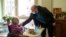 Marguerite Mouille, left, is greeted by her grandson Thierry Mouille at a nursing home in Kaysesberg, eastern France, Monday Dec. 21, 2020. (AP Photo/Jean-Francois Badias)