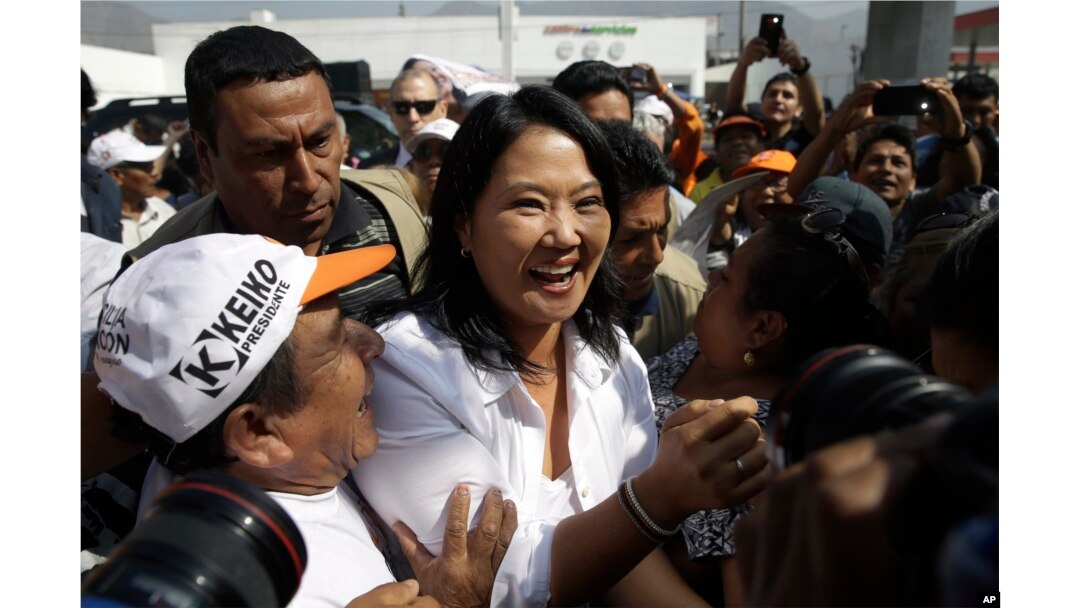 FILE - Presidential candidate Keiko Fujimori, center, of the Fuerza Popular political party, greets supporters as she campaigns in the San Juan de Lurigancho shantytown on the outskirts of Lima, Peru, May 10, 2016.