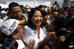 FILE - Presidential candidate Keiko Fujimori, center, of the Fuerza Popular political party, greets supporters as she campaigns in the San Juan de Lurigancho shantytown on the outskirts of Lima, Peru, May 10, 2016.