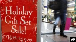 A retail store at the CambridgeSide Galleria mall in Cambridge, Massacjisetts, advertises holiday sale, December 24, 2012. 