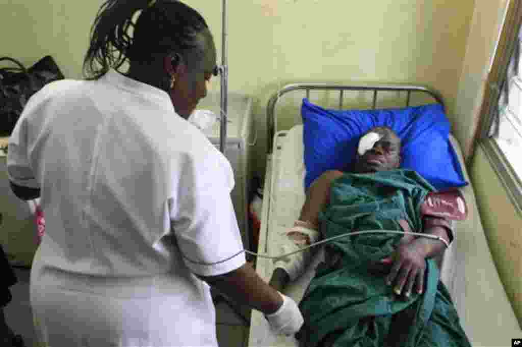 A nurse looks after Alex Iserhien, 55, who was recovering from injuries sustained during a suicide bombing one day earlier at United Nations headquarters, at the national hospital in Abuja, Nigeria Saturday, Aug. 27, 2011.