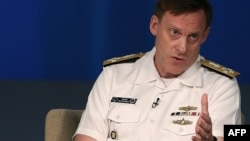U.S. Navy Admiral Michael Rogers, who heads U.S. Cyber Command and the National Security Agency, urges timely access to data. He's shown speaking at a forum in Washington, D.C, May 11, 2015. 