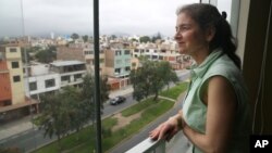 U.S. activist Lori Berenson looks out from her residence in Lima, Peru. Berenson is heading home to New York, two decades after being found guilty of aiding leftist rebels, Nov. 27, 2015.