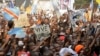 FILE - Supporters of Congolese opposition leader Etienne Tshisekedi carry placards and flags as they attend a political rally in the Democratic Republic of Congo's capital Kinshasa, July 31, 2016.