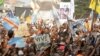 FILE - Supporters of Congolese opposition leader Etienne Tshisekedi carry placards and flags as they attend a political rally in the Democratic Republic of Congo's capital Kinshasa, July 31, 2016.