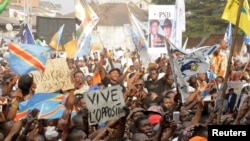 FILE - Supporters of Congolese opposition leader Etienne Tshisekedi carry placards and flags as they attend a political rally in the Democratic Republic of Congo's capital Kinshasa, July 31, 2016.