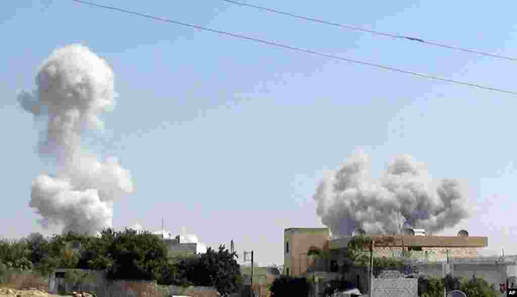 In this citizen journalism image provided by Edlib News Network, ENN, smoke rises after explosives were dropped by a Syrian government warplane in Idlib province, August 30, 2013.