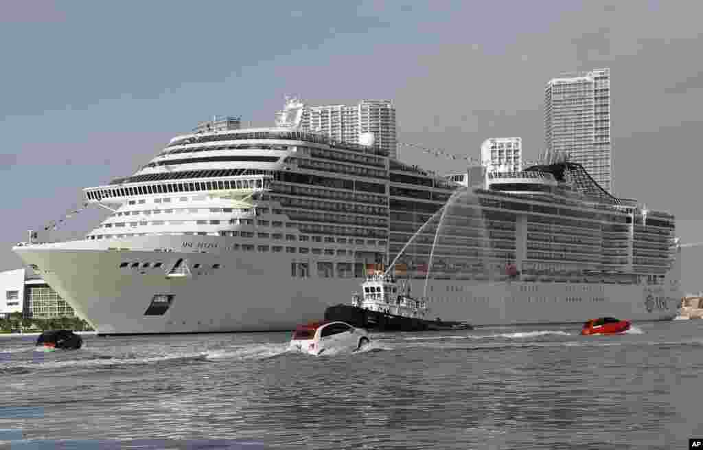 The MSC Divina cruise ship arrives at the Port of Miami, Florida, USA, escorted by a fleet of Fiat 500 watercrafts.