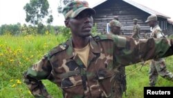 General Sultani Makenga, military leader of the M23 rebels, looks on while surrounded by his bodyguards at Mutaho, in eastern Democratic Republic of Congo, May 27, 2013.