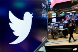 FILE - The logo for Twitter is displayed above a trading post on the floor of the New York Stock Exchange on Feb. 8, 2018.