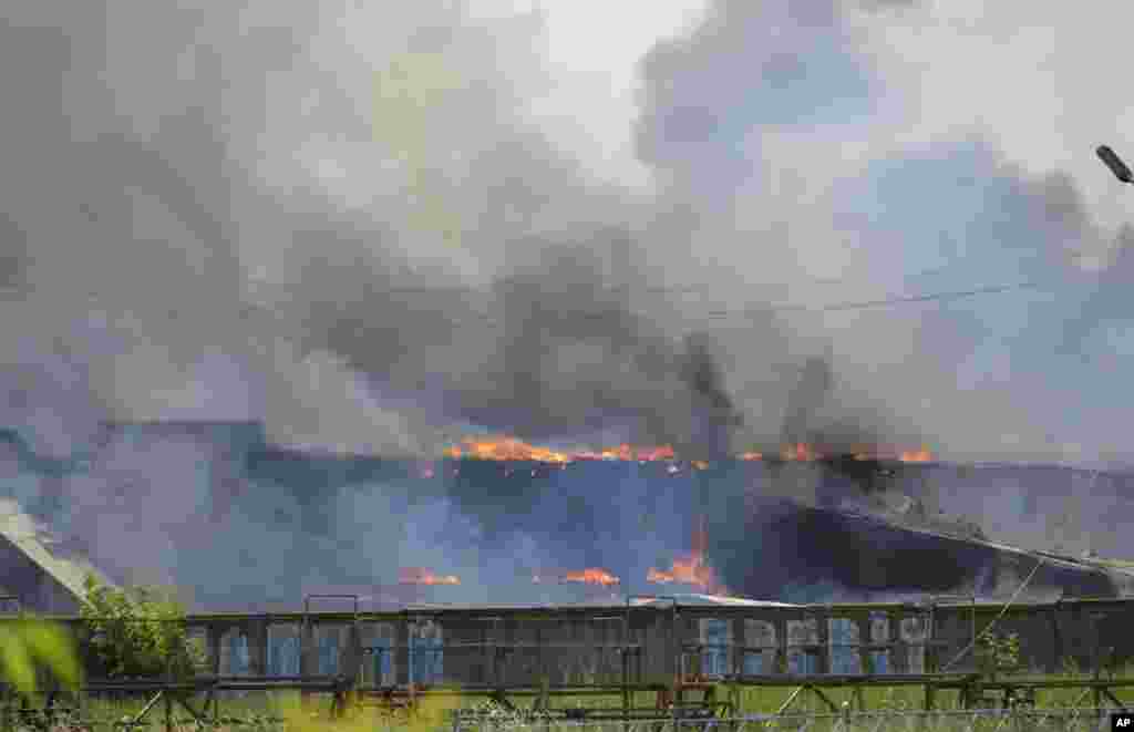 Smoke rises from the burning furniture factory after a mortar attack by Ukrainian government troops in Slovyansk, eastern Ukraine, June 8, 2014.