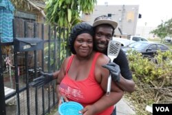 Anthony Bennett and his wife Val Williams, both residents of Miami’s Little Haiti, barbecue what remains in their stocked cooler. (Photo: R. Taylor / VOA)