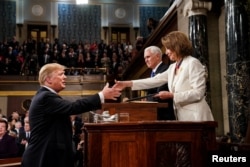 President Donald Trump, before delivering the State of the Union address, shakes the hand of Speaker of the House Nancy Pelosi. Vice President Mike Pence, center, is also in attendance at the Capitol in Washington, February 5, 2019.