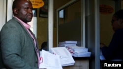 FILE - Tinomudaishe Chinyoka, one of the lawyers representing ZANU PF's Presidential candidate Emmerson Mnangagwa, arrives to file opposing papers at the Constitutional Court in Harare, Zimbabwe, Aug. 15, 2018.