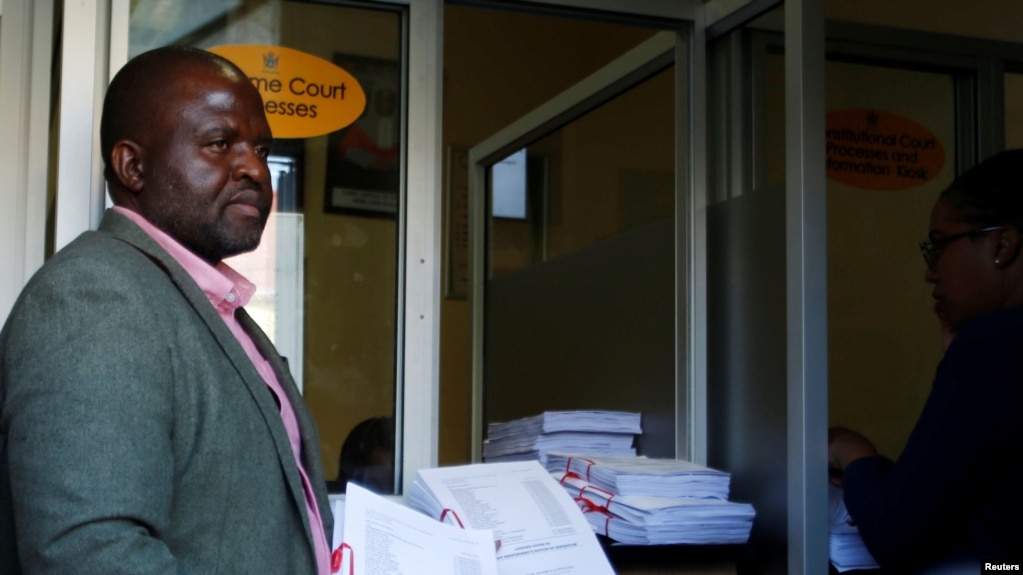 FILE - Tinomudaishe Chinyoka, one of the lawyers representing ZANU PF's Presidential candidate Emmerson Mnangagwa, arrives to file opposing papers at the Constitutional Court in Harare, Zimbabwe, Aug. 15, 2018.