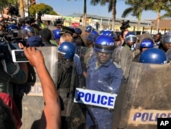 Riot police break up a press conference by opposition leader Nelson Chamisa in Harare, Zimbabwe, Aug. 3, 2018.